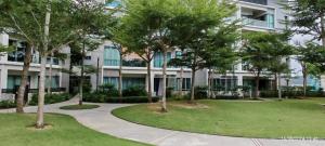 a building with trees in front of a building at Imago Loft Residences - By The Pool in Kota Kinabalu