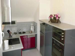 a kitchen with a sink and a counter with flowers on it at Apartment in Erquy near Emerald Coast Beaches in Erquy