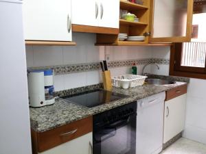 a kitchen with a sink and a dishwasher at Selgas de Cudillero in Cudillero