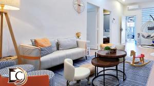 a living room with a couch and a table at Skudai - The9 Homestay 1min UTM, near Sutera Mall, Paradigm Mall, Senai airport in Skudai