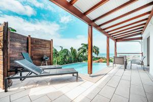 a house with a swimming pool and a patio at Appartement T4 - Villa Les Bougainvilliers in Les Trois-Îlets