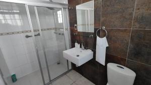 a bathroom with a shower and a sink and a toilet at Casa de Lucas in Balvanera +11 photos