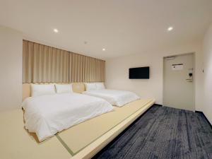 Postel nebo postele na pokoji v ubytování SAKURAKICHI Hotel