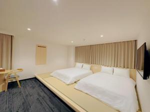 Postel nebo postele na pokoji v ubytování SAKURAKICHI Hotel