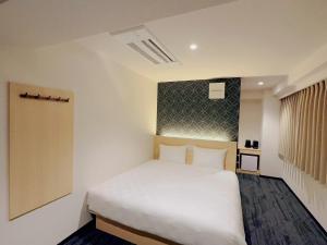 Postel nebo postele na pokoji v ubytování SAKURAKICHI Hotel