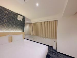 Postel nebo postele na pokoji v ubytování SAKURAKICHI Hotel