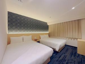 Postel nebo postele na pokoji v ubytování SAKURAKICHI Hotel