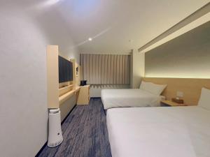 Postel nebo postele na pokoji v ubytování SAKURAKICHI Hotel