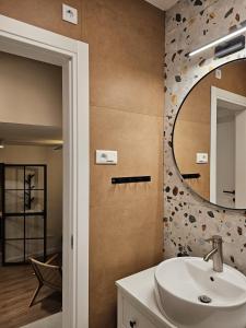 a bathroom with a sink and a mirror at Grandma's house in Rogoznica