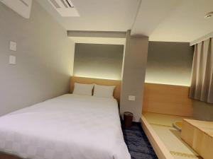 Postel nebo postele na pokoji v ubytování SAKURAKICHI Hotel