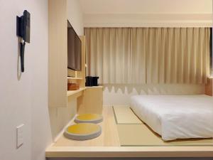 Postel nebo postele na pokoji v ubytování SAKURAKICHI Hotel