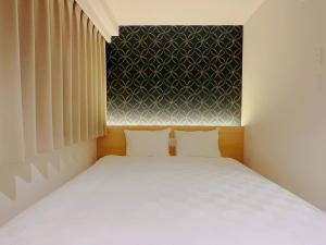 Postel nebo postele na pokoji v ubytování SAKURAKICHI Hotel