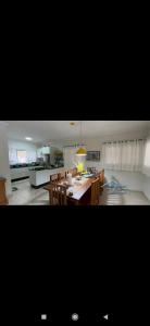 a kitchen and dining room with a table and chairs at Chácara Terra Prometida in Joanópolis +6 photos