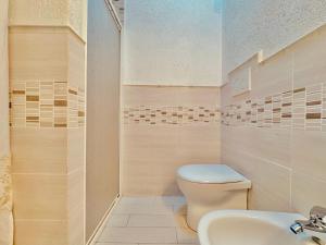 a bathroom with a toilet and a sink at Villetta i Pini in Baja Sardinia +19 photos