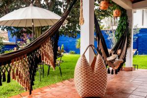 a couple of hammocks on a patio with an umbrella at Apartamento QUIRA 2 in Villa de Leyva