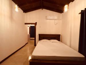 a bedroom with a bed in a room at Blue Heaven Guest House in Ahangama