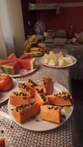 a table with three plates of cheese and fruit at Pousada Centaurus in Alto Paraíso de Goiás
