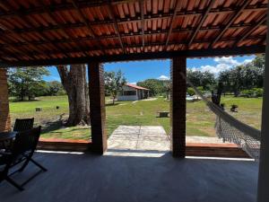 a view of a patio with a table and a tree at Fazenda Raiz da Serra in Itaguaí
