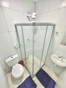 a bathroom with a shower and a toilet and a sink at Pousada Canaã in Recife