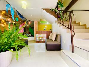 a living room with a staircase and a couch at Green Garden in Baños