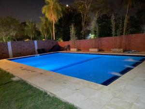 a swimming pool in a yard at night at Palina Village Casa 12 - San Bernardino in San Bernardino