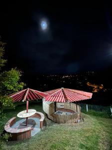 Blick auf eine Terrasse mit einem Tisch und einem Sonnenschirm in der Unterkunft Casa de Campo con mirador in Cuenca