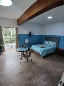 a bedroom with a bed and a table in it at Miraflores Kennedy Park in Lima