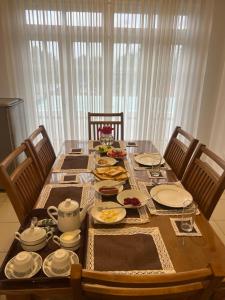 a dining room table with plates of food on it at TranquilZ in Kandy +10 photos