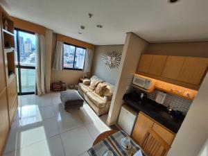 an overhead view of a living room with a couch at Flat Santana próximo ao metrô (Apto 135) in São Paulo