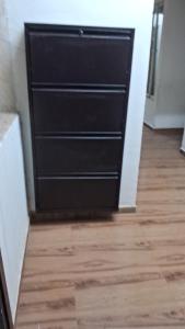 a black door in a room with a wooden floor at Decent furnished 1RK Navi Mumbai in Taloje