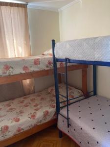 a bedroom with two bunk beds and a window at D11-4 Depto diario Arica in Arica