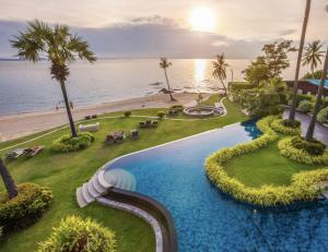 an aerial view of a resort swimming pool with the beach at The Palm Wongamat - 1BR Luxury Beachfront Suite - Ocean View - 32 Floor in Pattaya North