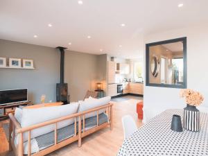 a living room with a couch and a table at Charmante maison 3 chambres Quentovic, WiFi - FR-1-821-11 in Le Touquet-Paris-Plage