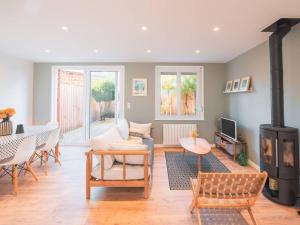 a living room with a fireplace and a table and chairs at Charmante maison 3 chambres Quentovic, WiFi - FR-1-821-11 in Le Touquet-Paris-Plage