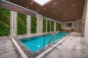 a swimming pool in a building with an indoor at The Paradise Pool House Since 2025 in Danang