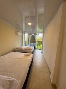two beds in a room with a hallway at Sierra Serena Habitaciones in Santa Marta