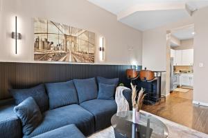 a living room with a blue couch and a table at Soulard Suite in Saint Louis