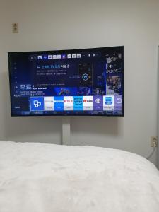 a flat screen tv hanging on a wall at K Hubhouse - Taereung stn 5min walk#villa 4pax in Seoul