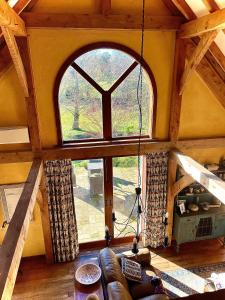an overhead view of a living room with a large window at Streamside Country Manor- Matamata in Matamata