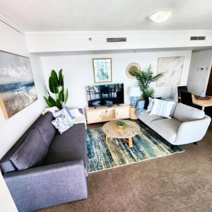a living room with a couch and a table at Hampton's Haven on Level 17 in Casino Towers in Brisbane
