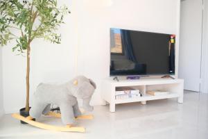 a stuffed elephant riding a skateboard in a living room at A2 Airport 2BR Haven - Garden & Parking in Perth