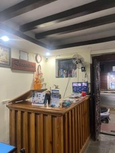 a shop with a wooden counter with a fan at Hotel Blue lake in Pokhara