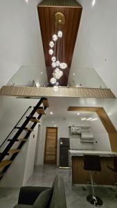 two pictures of a lobby with a staircase and a room at BILDO VILLA and HOMESTAY in Moalboal