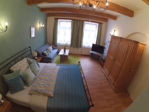 a bedroom with a bed and a living room at Hotel Atrium in Jihlava