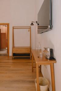 a room with a table and a mirror on the wall at Hotel Boutique Casa Yága in Querétaro
