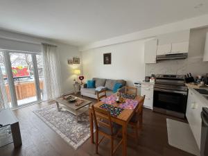 a kitchen and a living room with a table and chairs at Brand New 2 story unit in Richmond Hill