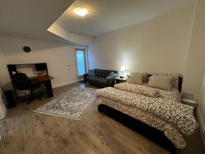 a bedroom with a bed and a couch and a desk at Brand New 2 story unit in Richmond Hill