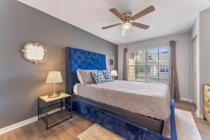 a bedroom with a blue bed with a ceiling fan at 4005 SAN SABASTIAN DRIVE 3BED in Kissimmee +27 photos