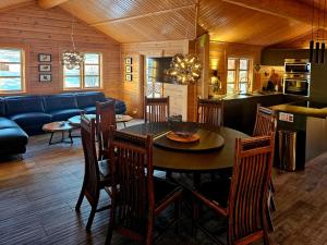 a kitchen and dining room with a table and chairs at Aurora Vacation Homes Fagravik in Akureyri