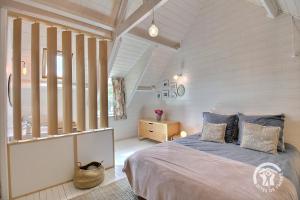 a bedroom with a bed in a room with white walls at La villa de la lieue de greve in Plestin-les-Grèves +44 photos